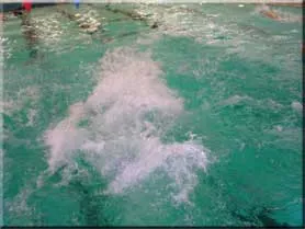 Swimming pool with splashes of water, illustrating swimming lessons at The Aqua Life Swim Academy.